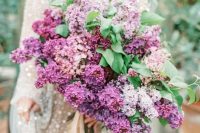 30 a classic lilac wedding bouquet with greenery is a gorgeous idea for a spring bride, add some leaves for a catchy look