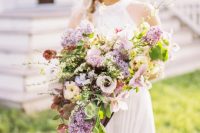 31 a fantastic lilac and blush wedding bouquet of anemones and lilac blooms, blooming branches and greenery and long ribbon for a spring bride