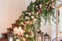 33 a super lush and gorgeous staircase decorated with greenery, neutral and bold blooms, candles and vintage candleholders for a wedding