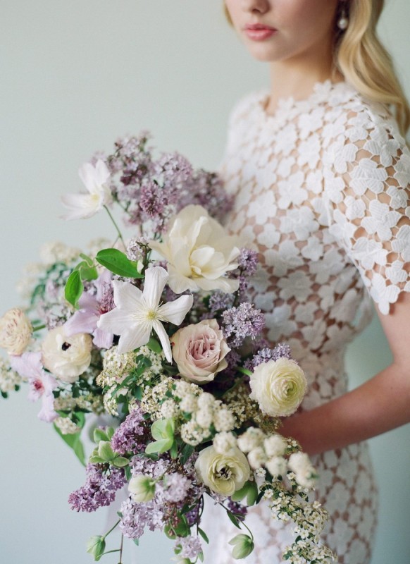 a pastel wedding bouquet with lots of lilac and pale pink blooms, neutral and blush ones and greenery is a fantastic and lush idea for a spring bride