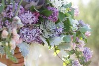 35 a super lush and catchy wedding bouquet of lilac and white lilac, lots of greenery, pale leaves, succulents is a lovely idea for a spring bride