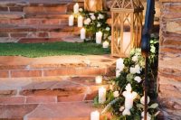 35 cute rustic wedding decor with greenery and white blooms, white candles and wooden candle lanterns is lovely