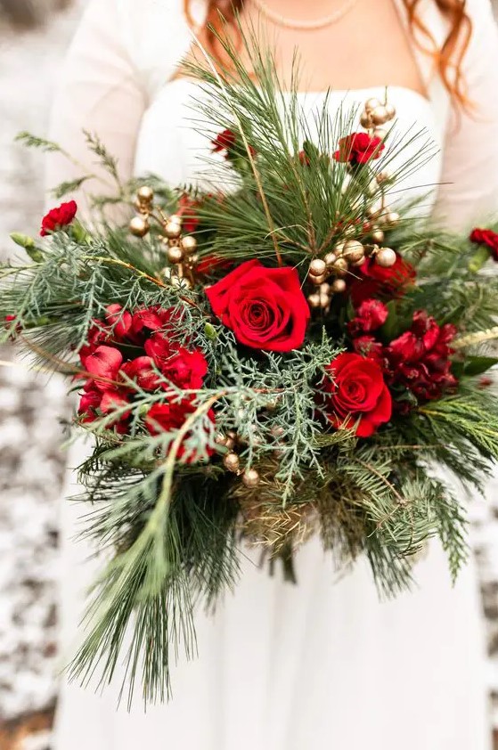 a Christmas wedding bouquet of red and burgundy blooms, greenery and gilded berries is a chic idea