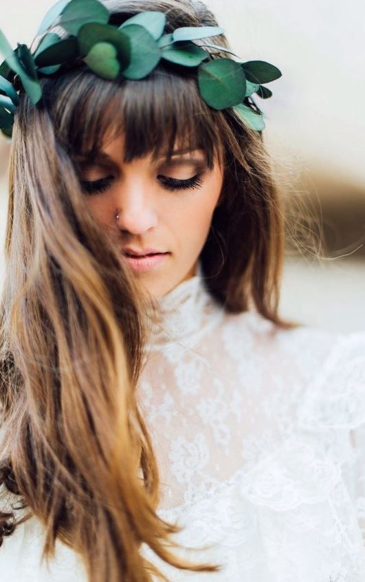 a bold leafy bridal crown adds a fresh feel to the look and makes a statement with its emerald shade at once