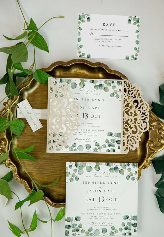 a botanical wedding invitation suite with black printing is paired with a neutral laser cut jacket for a more eye-catchy look