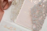 a breathtaking refined and glam wedding invitation suite with a blush invite with foiling and a laser cut jacket with silver glitter
