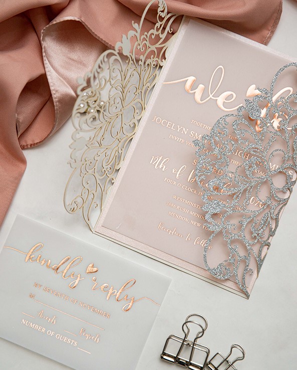 a breathtaking refined and glam wedding invitation suite with a blush invite with foiling and a laser cut jacket with silver glitter