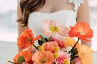 a bright wedding bouquet of orange and light pink poppies, white, orange and pink ranunculus, billy balls and some greenery