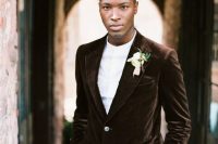 a casual groom’s look with navy pants, a white shirt and a brown velvet blazer for a modern wedding