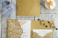 a chic and bold gold and white wedding invitation suite with laser cut detailing and calligraphy for a chic and glam wedding