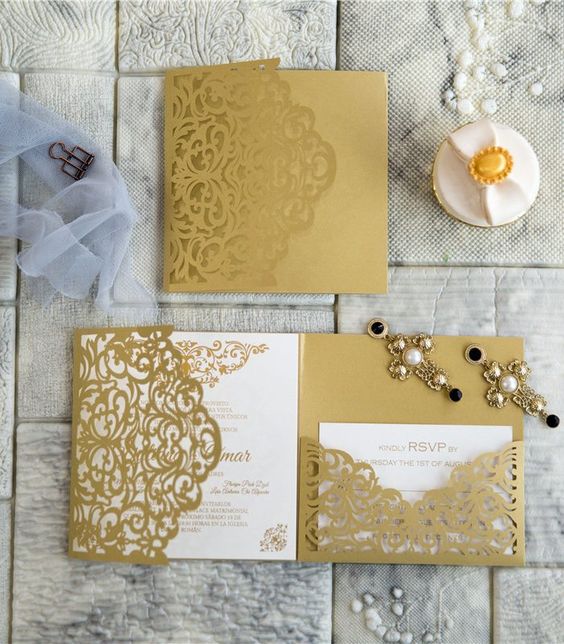 a chic and bold gold and white wedding invitation suite with laser cut detailing and calligraphy for a chic and glam wedding