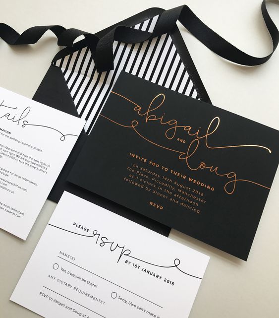 a chic black and white wedding invitation suite with black and gold foil calligraphy, a striped lining envelope is wow