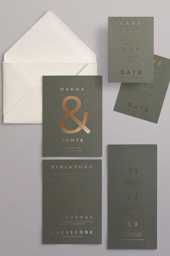 a chic modern wedding invitation suite with a white envelope, olive green invites and cards and gold foil calligraphy plus letterpressing