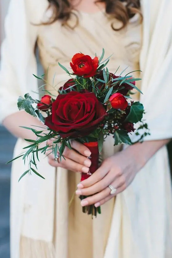 a chic red wedding bouquet of blooms and foliage is all you need for a stylish Christmas wedding
