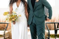 a cool modern groom’s look with a grene pantsuit, a black turtleneck, black lacquer loafers and a bold floral boutonniere