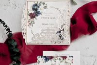 a cool wedding invitation suite with a neutral floral laser cut jacket and bold floral print invitations fro a bold wedding