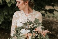 a dress embroidered with leafy motifs practically mandates a matching greenery crown, a great look for a garden wedding