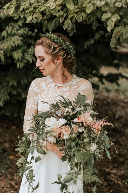 a dress embroidered with leafy motifs practically mandates a matching greenery crown, a great look for a garden wedding