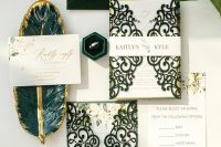 a fantastic wedding invitation suite with a green velvet envelope, green laser cut jackets and gold calligraphy is amazing