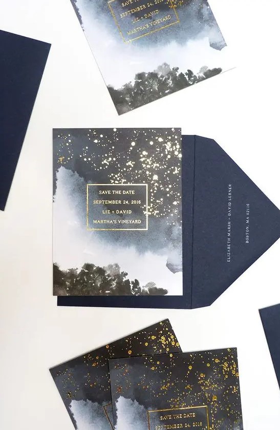 a galaxy-inspired wedding invitation suite with gold flecks that show stars looks absolutely jaw-dropping
