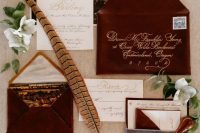 a gorgeous fall wedding invitation suite with burgundy velvet envelopes, with calligraphy invites and scenery lining of the envelopes is wow