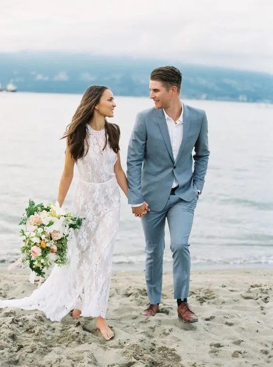 a grey blue suit, a white shirt and brown shoes for a modern seaside wedding