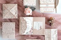 a jaw-dropping and refined blush laser cut wedding invitation suite with a floral pattern and florla print is wow