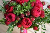 a lovely bold red wedding bouquet of peonies, greenery and succulents plus a pink bouquet wrap is amazing for a bright wedding