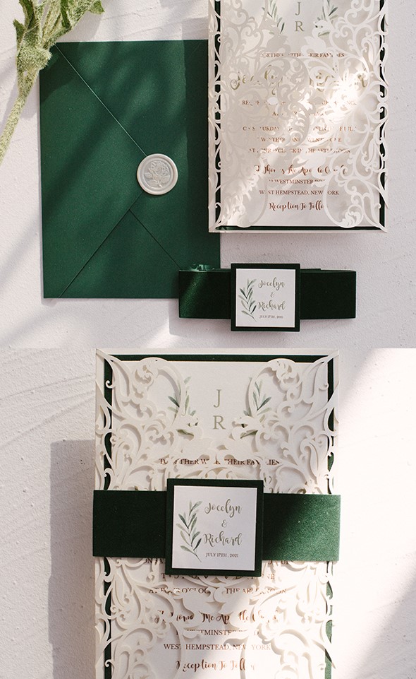a lovely wedding invitation suite with a green envelope, white laser cut jackets, green ribbon and name accents is wow