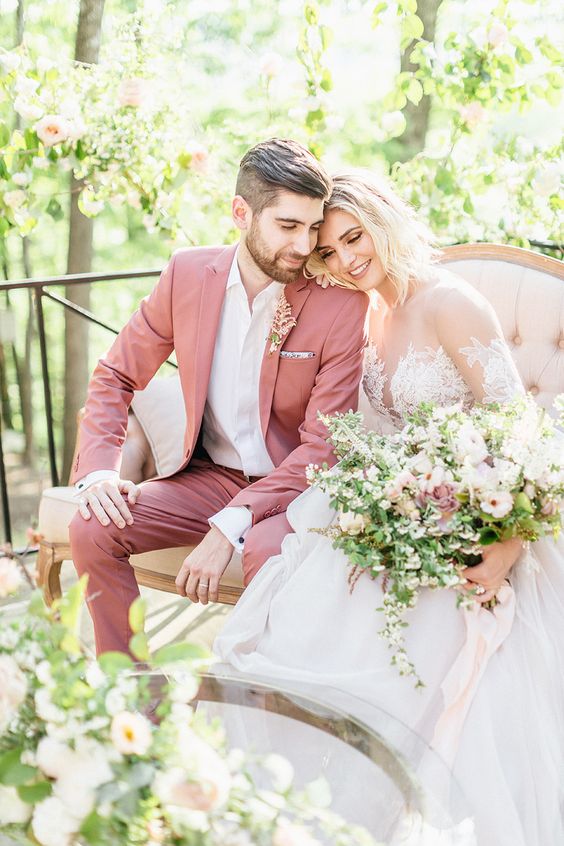 a mauve pantsuit, a white shirt and a delicate pink flower boutonniere are amazing for a spring or summer garden wedding