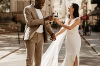 a minimalist and chic groom’s look with a tan pantsuit, a white t-shirt and black shoes is a great idea for a neutral wedding