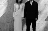 a minimalist outfit with a black pantsuit, a white shirt and black loafers is a perfect idea for a minimalist wedding