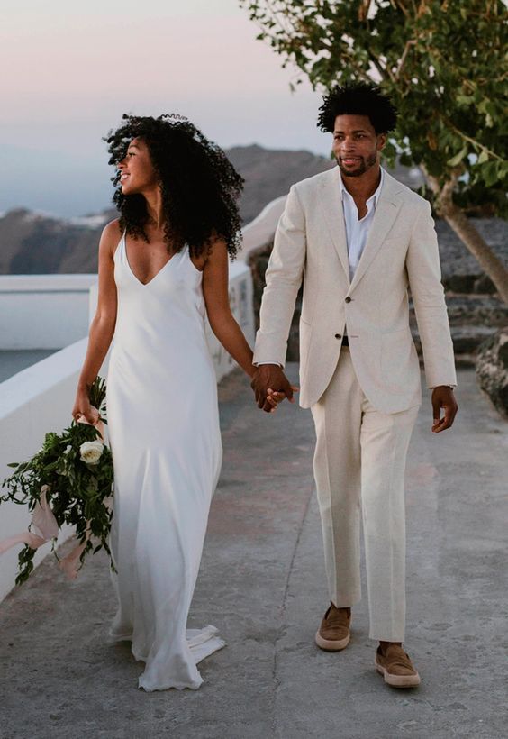 a minimalist summer groom's look with a neutral linen pantsuit, a white shirt and brown shoes is amazing