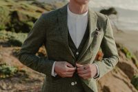 a modern and catchy groom’s outfit with a grey green three piece suit, a white shirt and no tie or boutonniere is amazing