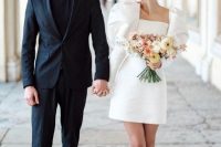 a modern and elegant groom’s look with a black pantsuit, a black turtleneck, black leather boots is a great idea to rock