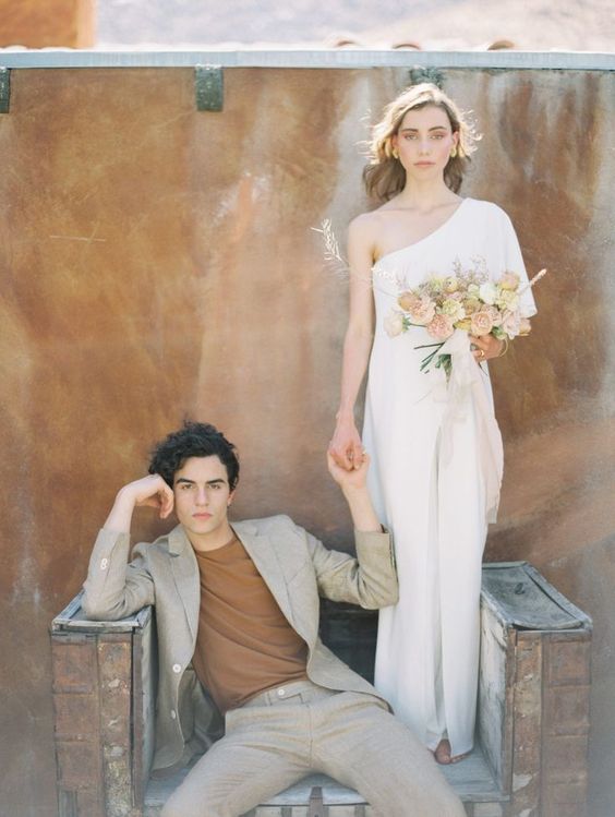 a modern groom's look with a grey pantsuit and a rust t-shirt is a lovely idea for a modern desert wedding