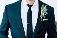 a modern look with a black suit and black tie plus a greenery boutonniere is a win-win idea to rock