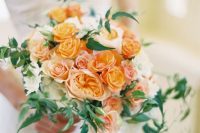 a monochromatic orange wedding bouquet of roses, peony roses and greenery is a lovely idea for a summer or fall wedding