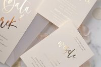 a neutral and cool wedding invitation suite with gold foil calligraphy is a lovely and chic idea for a modern and stylish wedding