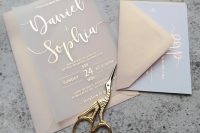 a pretty and catchy wedding invitation suite with pastel envelopes, blue and vellum cards with rose gold foil calligraphy is adorable