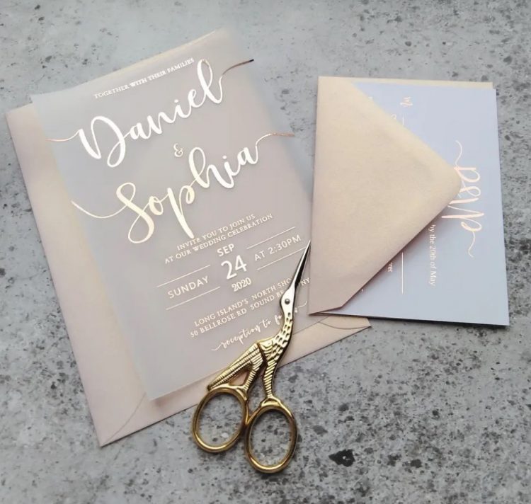 a pretty and catchy wedding invitation suite with pastel envelopes, blue and vellum cards with rose gold foil calligraphy is adorable