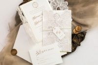 a refined neutral laser cut flower wedding invitation suite with gold calligraphy is a very delicate and chic idea for a wedding