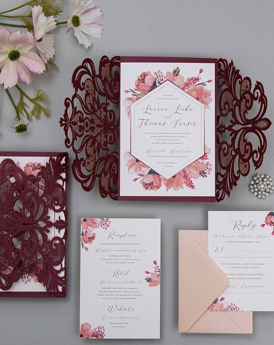 a stylish blush and burgundy wedding invitation suite with laser cut jackets and floral print is a lovely idea