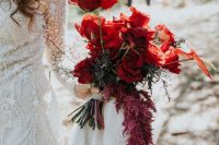 a super chic bold red rose wedding bouquet with lisianthus, greenery and blooming branches is a bold and cool idea to rock