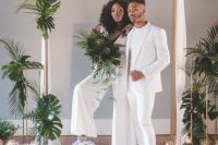 an all-white minimalist groom’s look with a white pantsuit, a white t-shirt, sneakers is a lovely idea for a minimalist all-white wedding