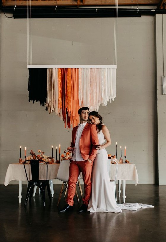 an orange suit, a white shirt, black shoes for a stylish modern wedding with a bold touch of color
