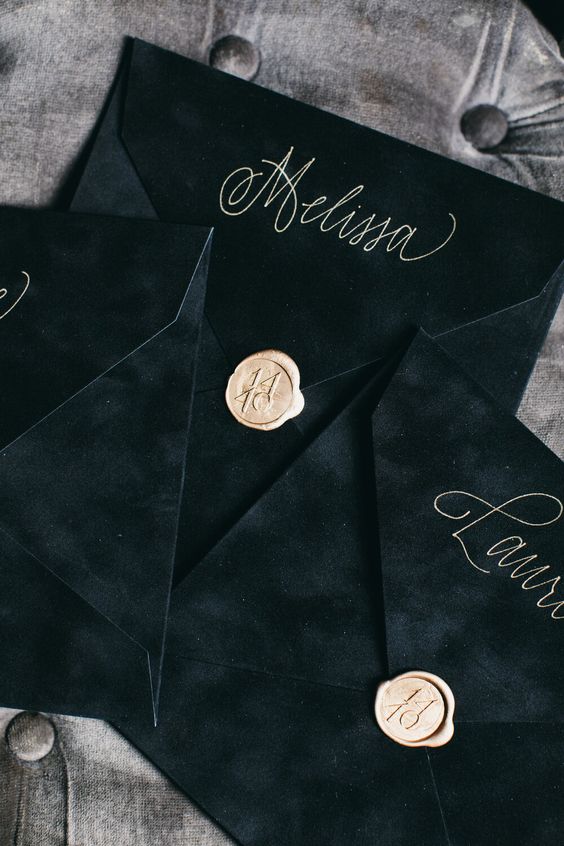 black velvet envelopes with gold calligraphy and gold seals are amazing for a sophisticated wedding with black in the color scheme