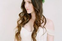 long wavy locks accented with a greenery crown look gorgeous and absolutely dreamy