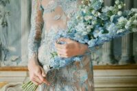 04 a blue lace applique and embroidery wedding dress paired up with a blue and white delphinium wedding bouquet