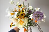 04 a unique bright wedding bouquet with white blooms, yellow and orange ones, with allium is a lovely idea for spring or summer